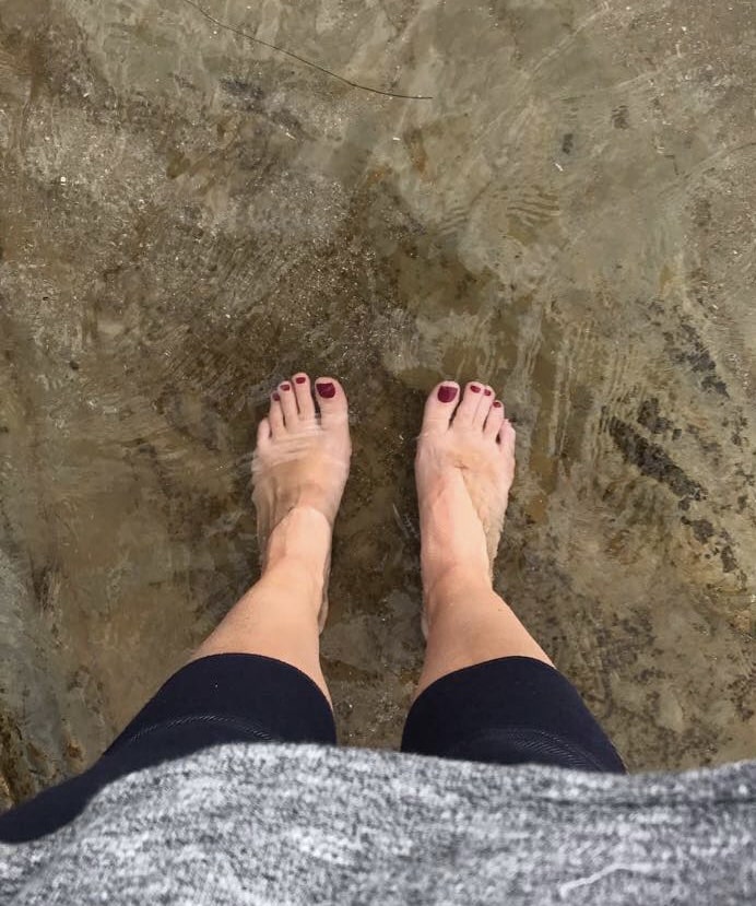 bare feet in the ocean