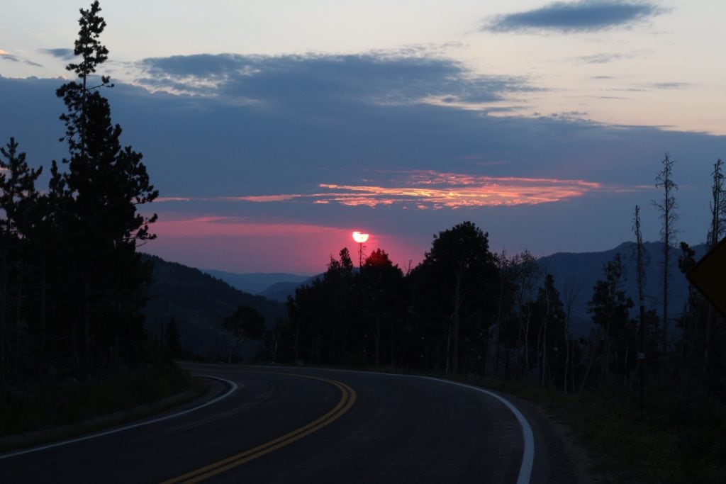 pink sunrise over a curvy road in Rocky Mountain National Park