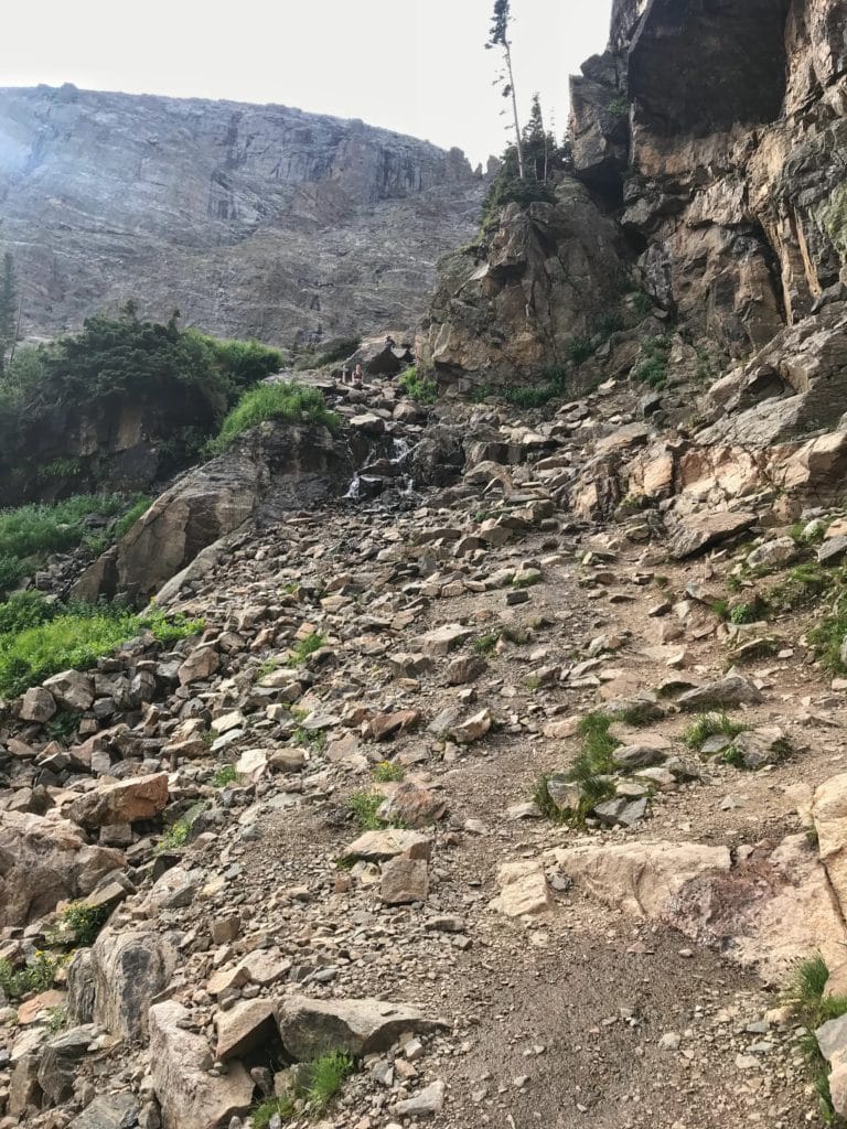 lots of rocks forming a trail through rocky mountains